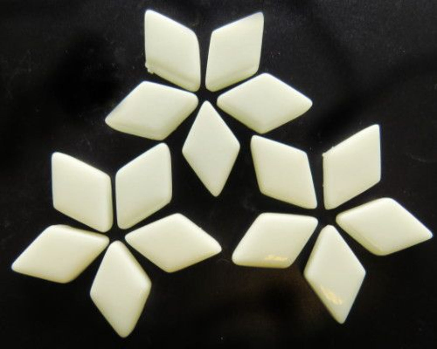 Beige glass diamond tiles on a black backgound