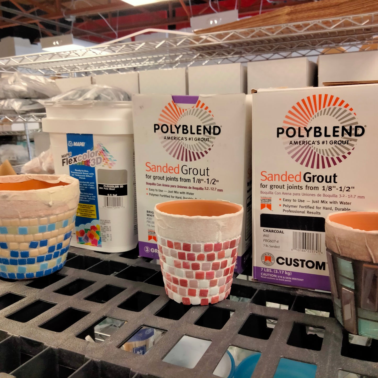 A workshop image showing different brands of grout containers