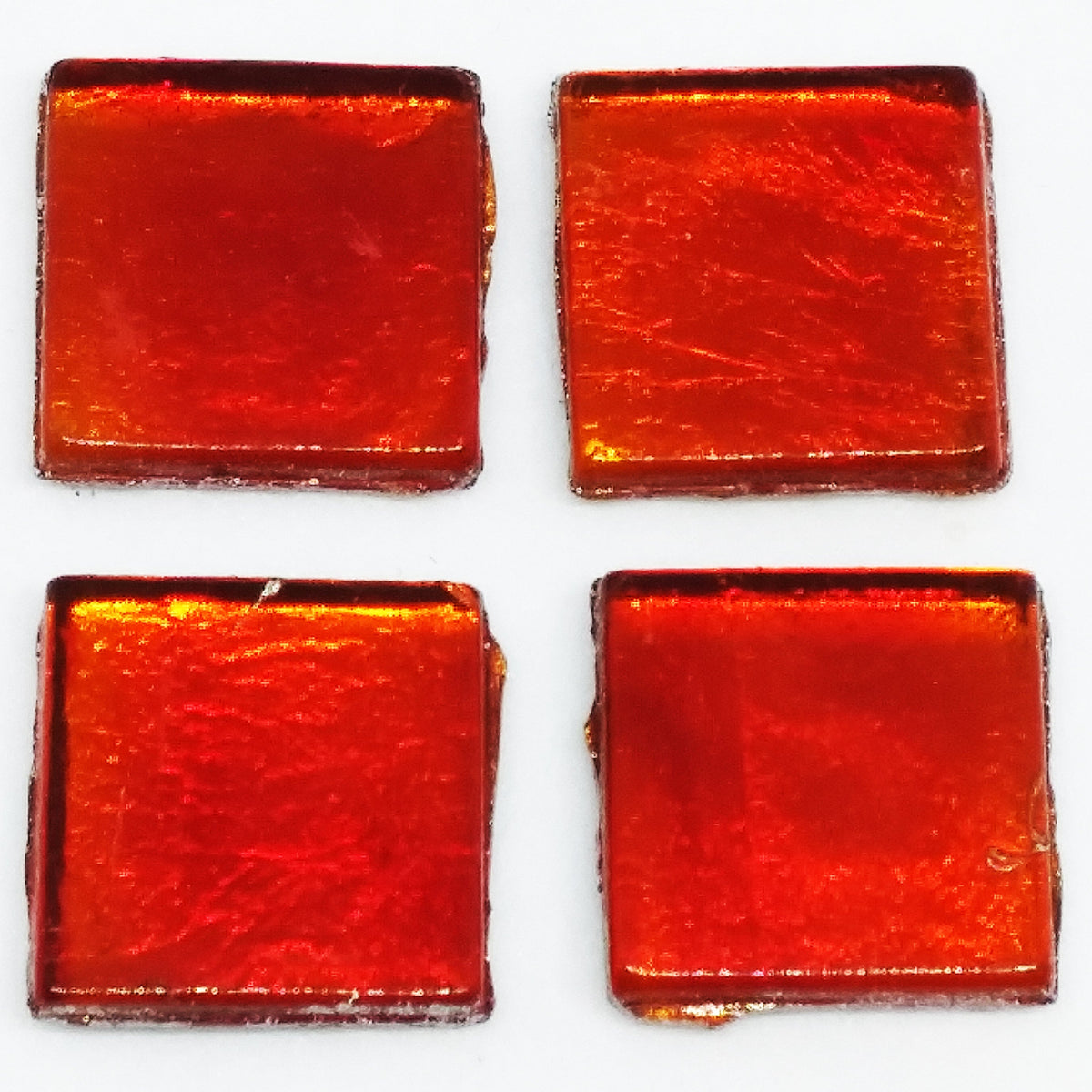 Translucent red glass tile with metallic backing.