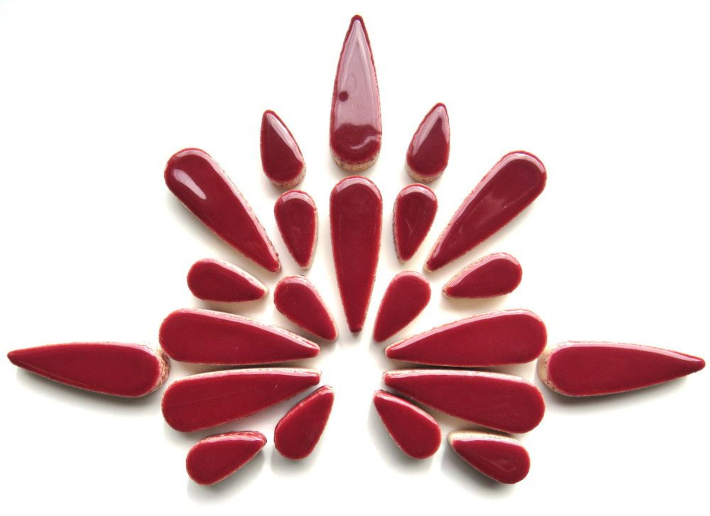 Ceramic teardrop mosaic tiles in vibrant wine red, arranged in a decorative pattern, showcasing artistic design for DIY projects.
