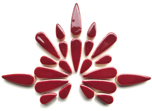 Ceramic teardrop mosaic tiles in vibrant wine red, arranged in a decorative pattern, showcasing artistic design for DIY projects.