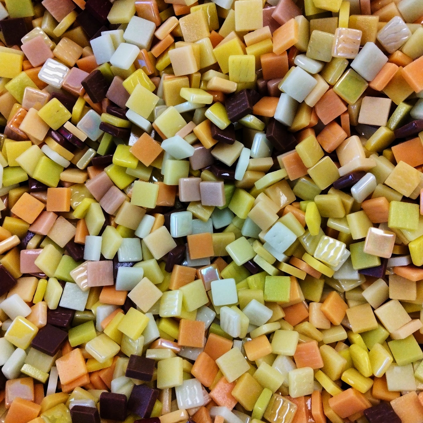 A mix of yellow, tan, and brown recycled glass mosaic tiles.

