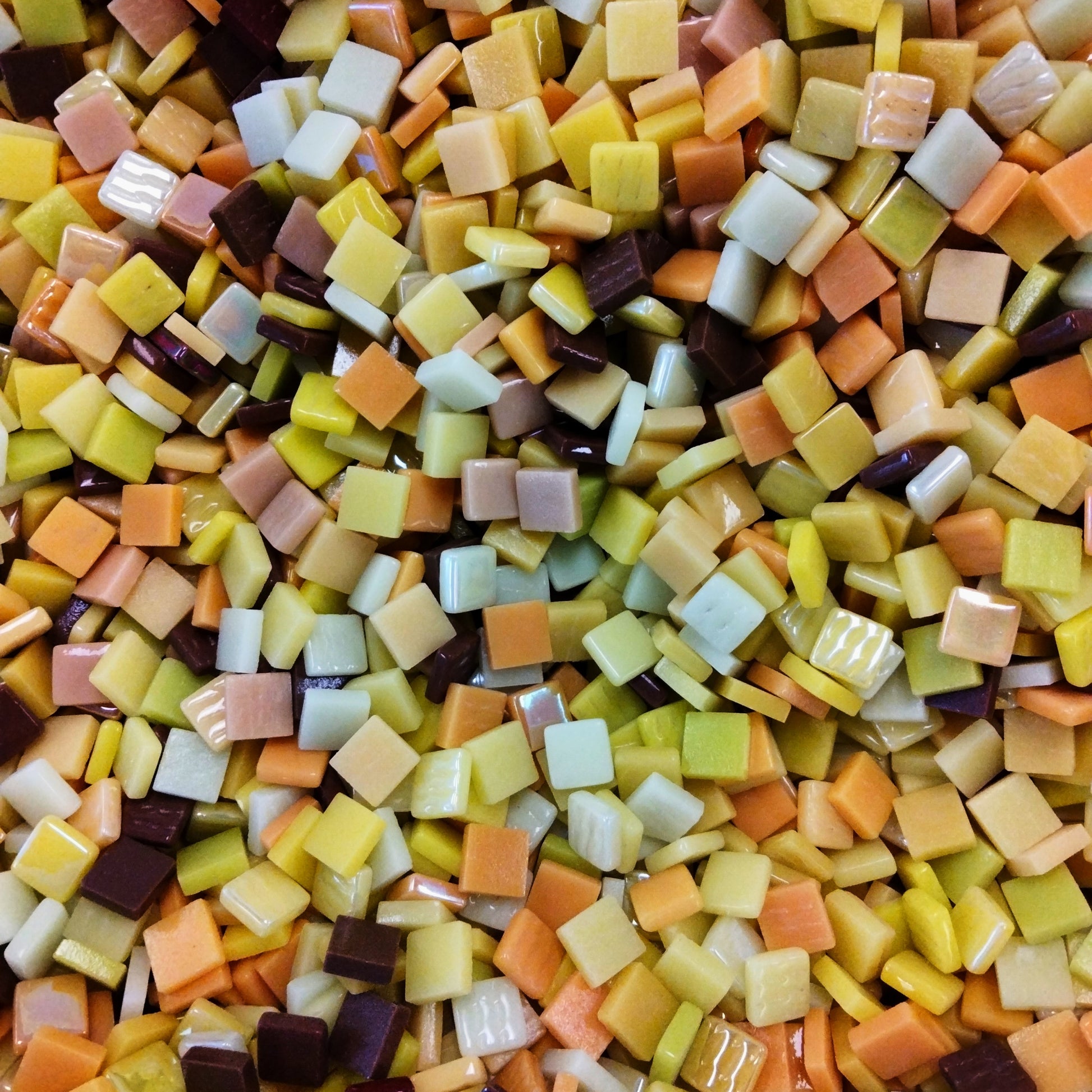 A mix of yellow, tan, and brown recycled glass mosaic tiles.

