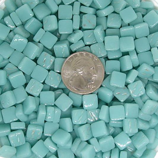 8mm light teal mosaic glass tiles with a quarter for size reference, showcasing vibrant color and glossy finish, ideal for artistic projects.
