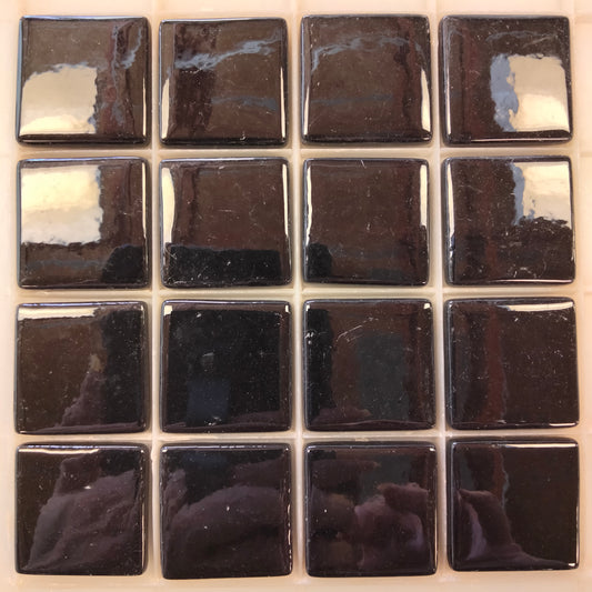 Glossy black porcelain mosaic tiles arranged in a 4x4 grid, suitable for wet or dry environments in artistic and decorative applications.