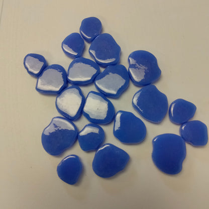 A collection of blue periwinkle glossy mosaic tiles with a petal shape.