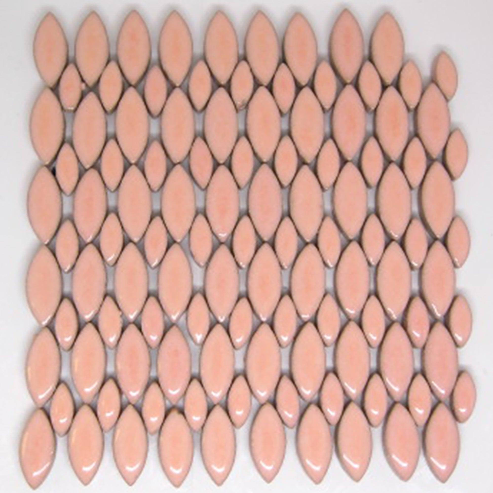 Glazed ceramic mosaic tiles in blush color arranged in a decorative pattern. The tiles feature an elongated petal or leaf shape in two sizes - larger and smaller ellipses. The blush glaze has a soft peachy-pink tone with a glossy, reflective finish. The pattern shows an average number tile in the 4 oz package.
