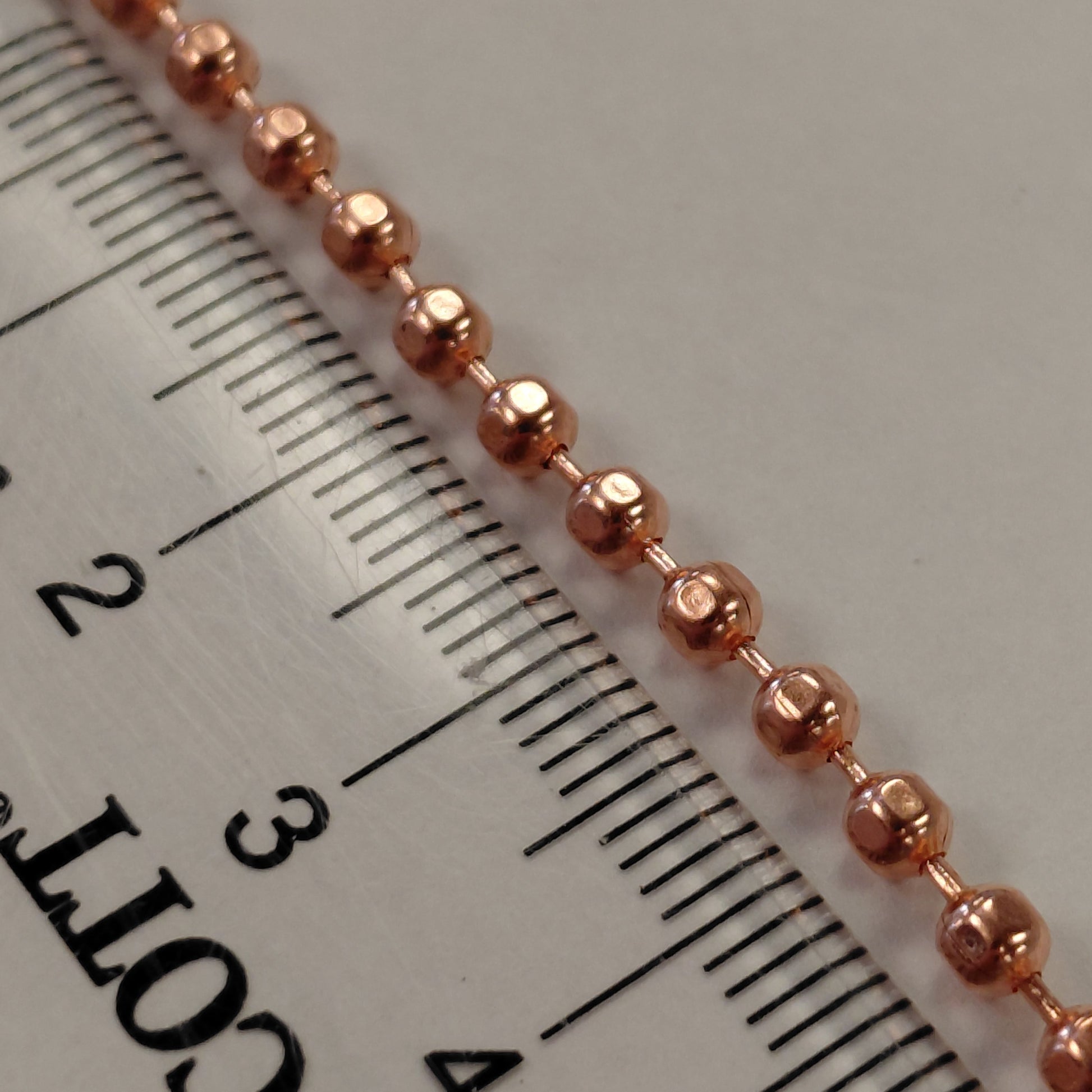 faceted copper ball chain closeup