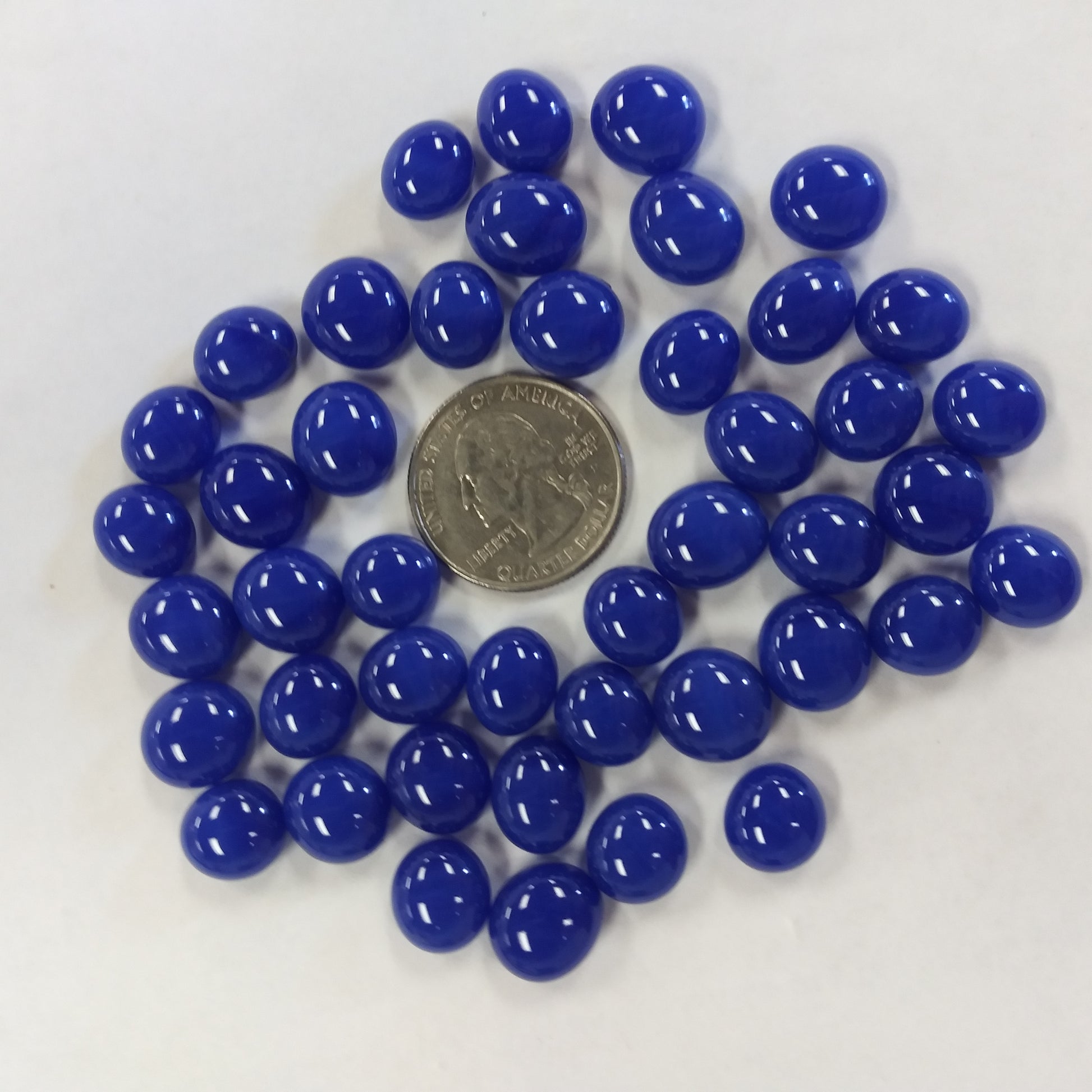 A collection of blue glass mini gems with a high-gloss finish.