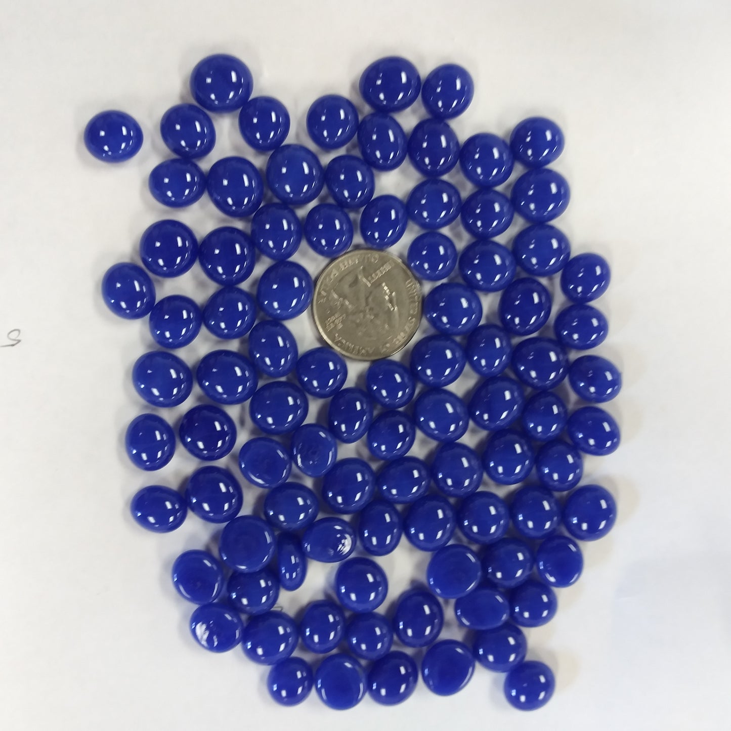 A collection of blue glass mini gems with a high-gloss finish.