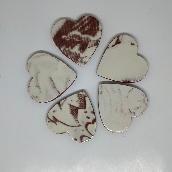 Handmade Ceramic Heart--Red Clay with white glaze  This limited edition product is 1.5" wide by 1.5" tall by 3/16" (5mm) deep.  These high fire pieces have a red clay body with a white glaze.   I can't get them again, so when they're gone, they're gone.