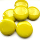 A collection of extra large yellow glossy tiles arranged in a pattern on a white background.