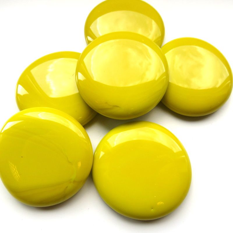 A collection of extra large yellow glossy tiles arranged in a pattern on a white background.